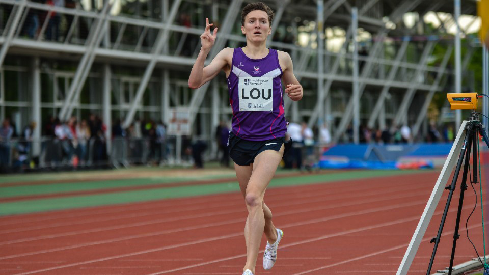Runner in purple on track with 'LOU' bib, gesturing mid-stride.